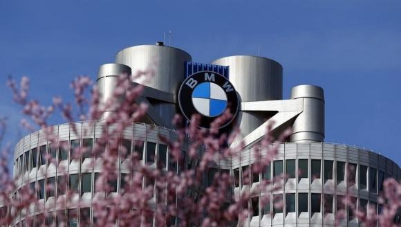 Trees bloom in front of the headquarters of German luxury car maker BMW in Munich